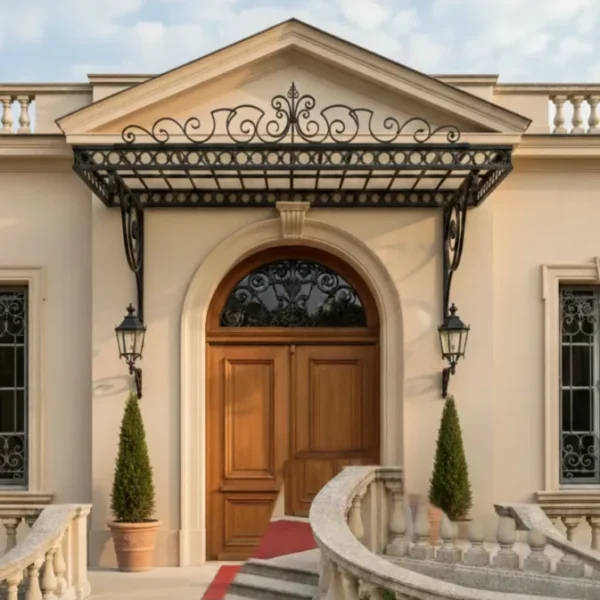 Large ornate black wrought iron canopy with a central decorative crown and a flat glass roof, installed over a grand villa entrance with a red carpet and curved stone stairs.